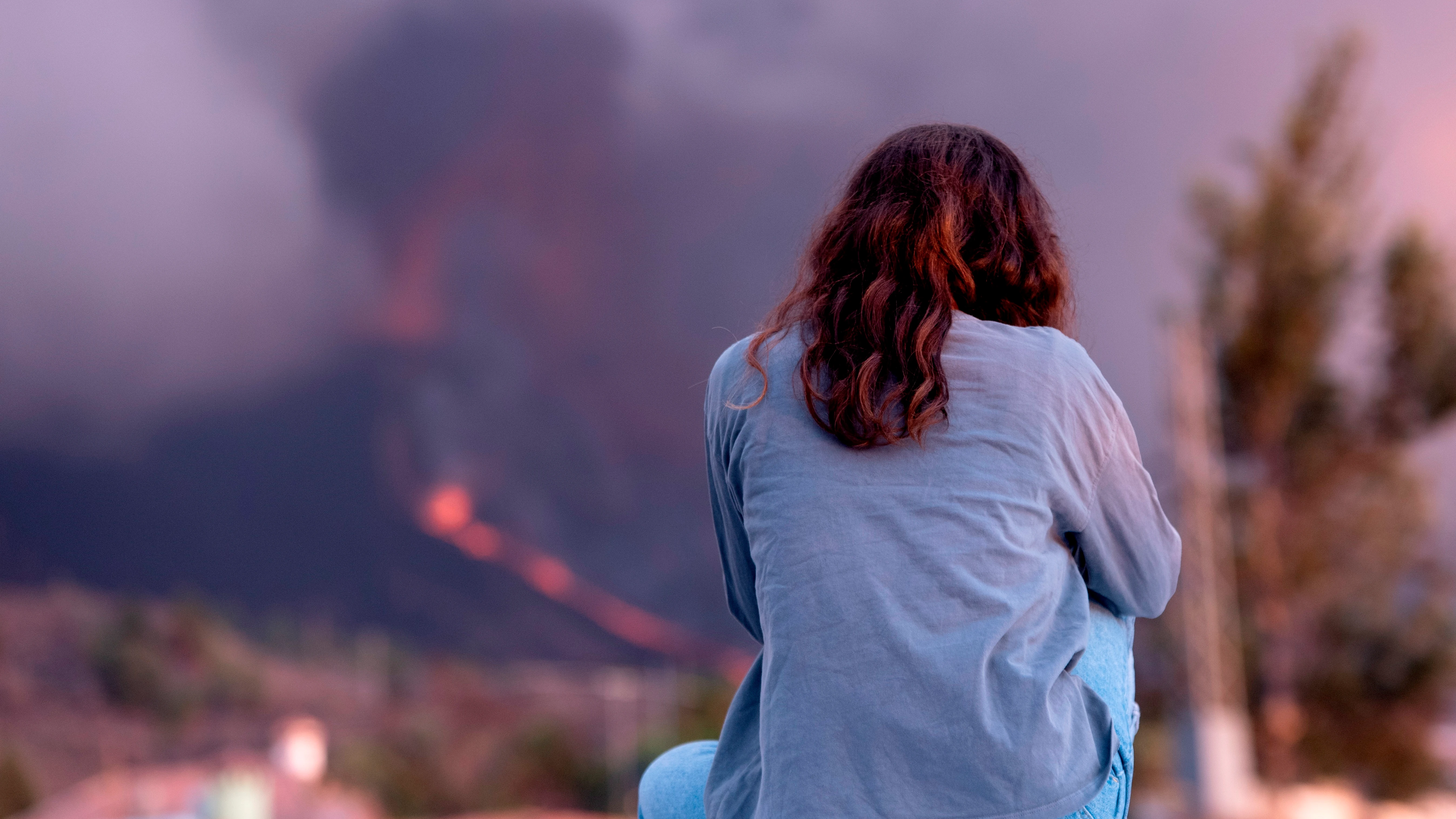 Una mujer observa el volcán de La Palma