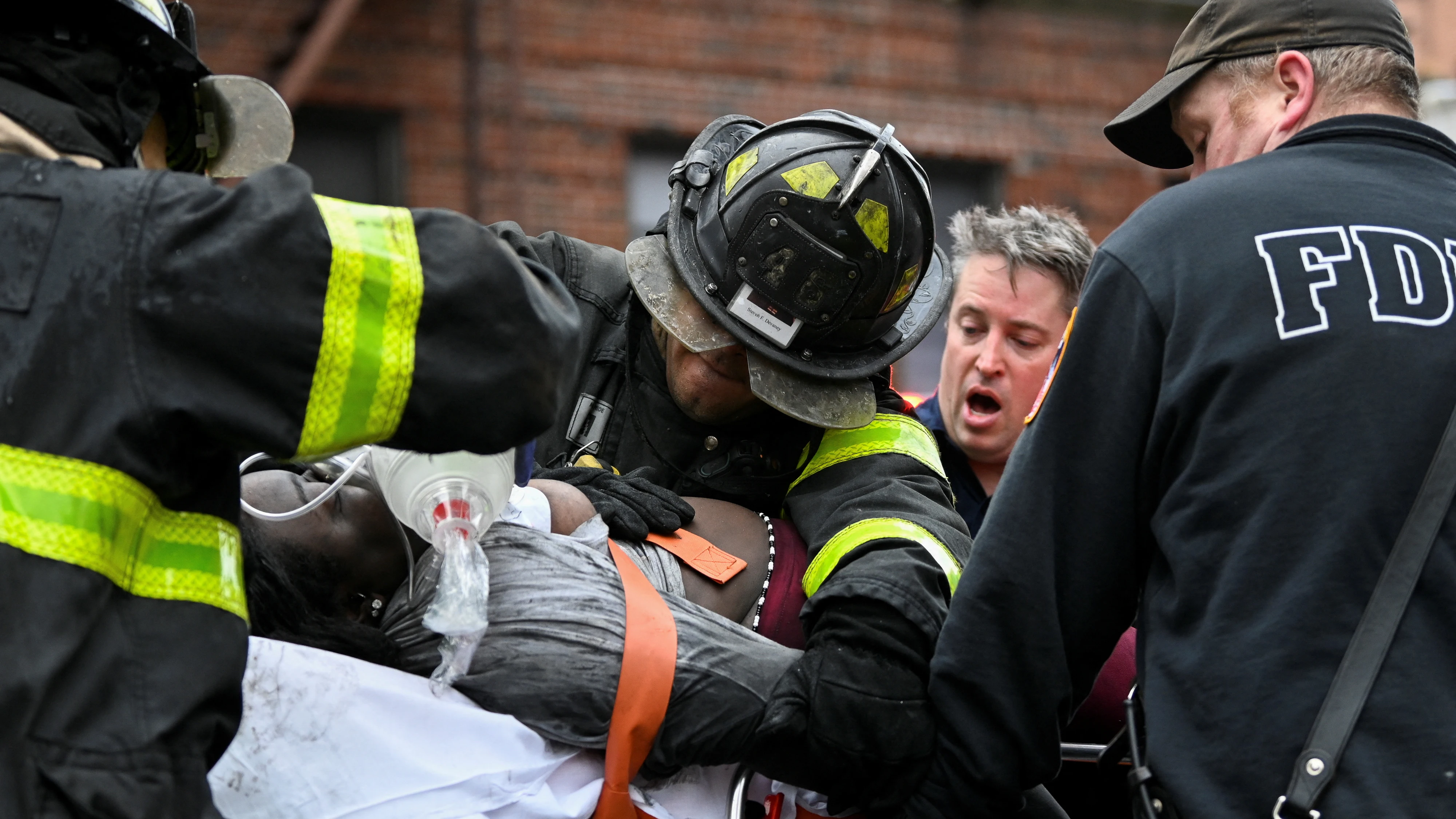 Bomberos atienden a una de las personas afectadas en el incendio del Bronx (Nueva York, EEUU)