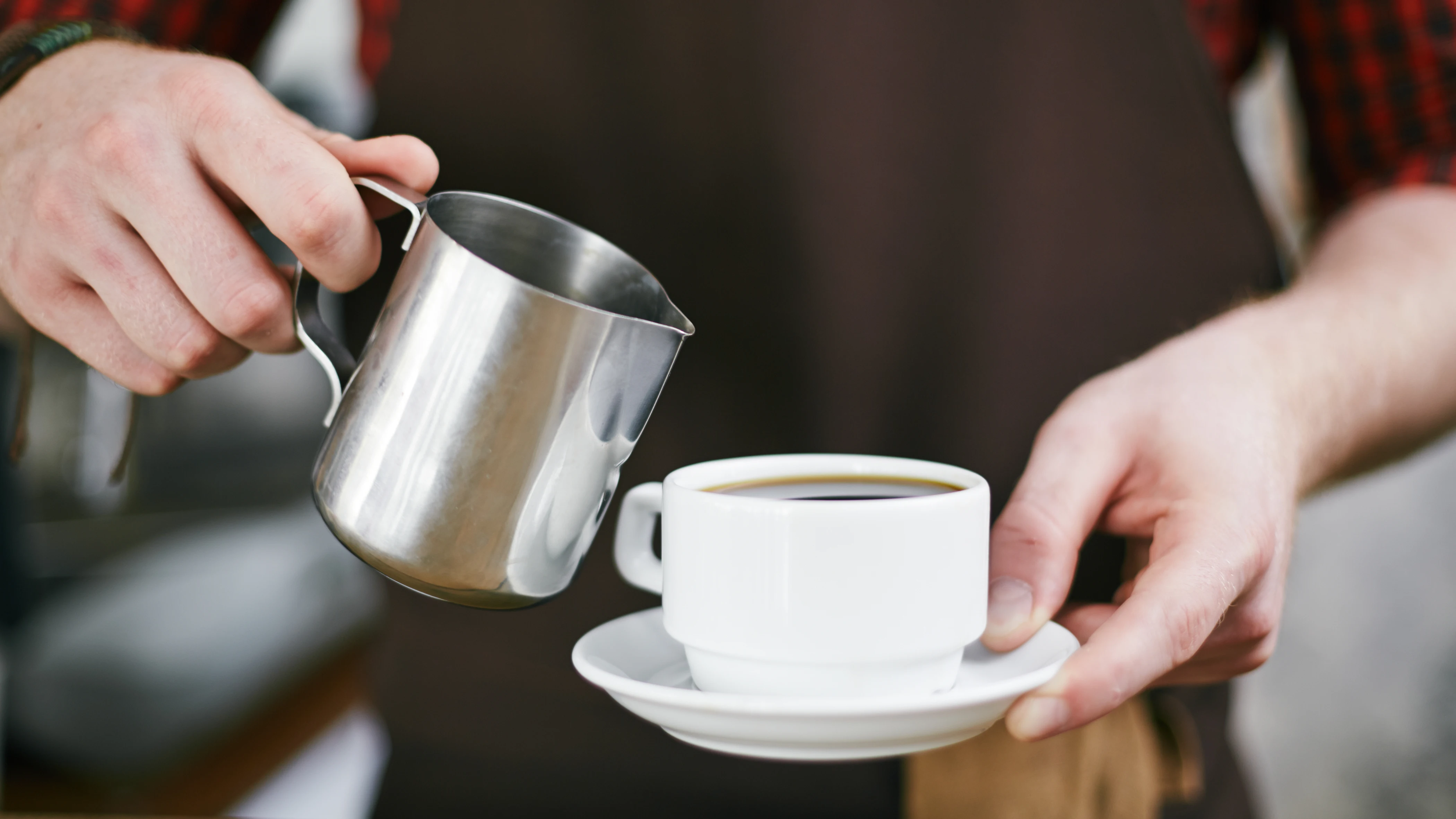 Camarero ofreciendo café en una cafetería