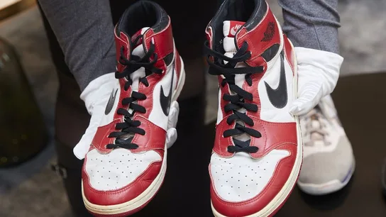 Un par de Air Jordan 1 utilizadas por Michael Jordan, sujetas por un empleado de Sotheby's. Un par de Air Jordan 1 utilizadas por Michael Jordan, sujetas por un empleado de Sotheby's.