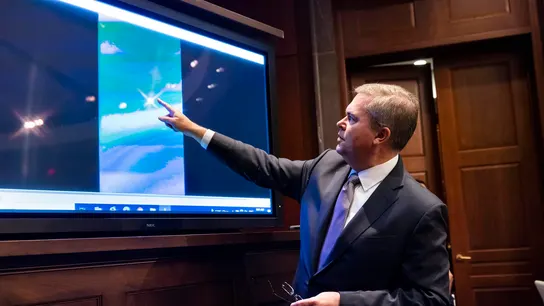 El subdirector de inteligencia naval, Scott Bray, reproduce un video de un "fenómeno aéreo no identificado". El subdirector de inteligencia naval, Scott Bray, reproduce un video de un "fenómeno aéreo no identificado".