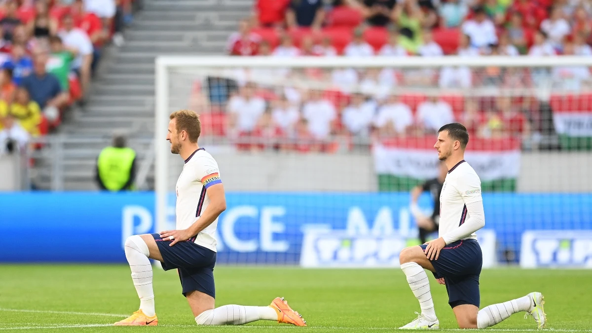 Harry Kane y Mason Mountse arrodillan en su partido contra Hungría