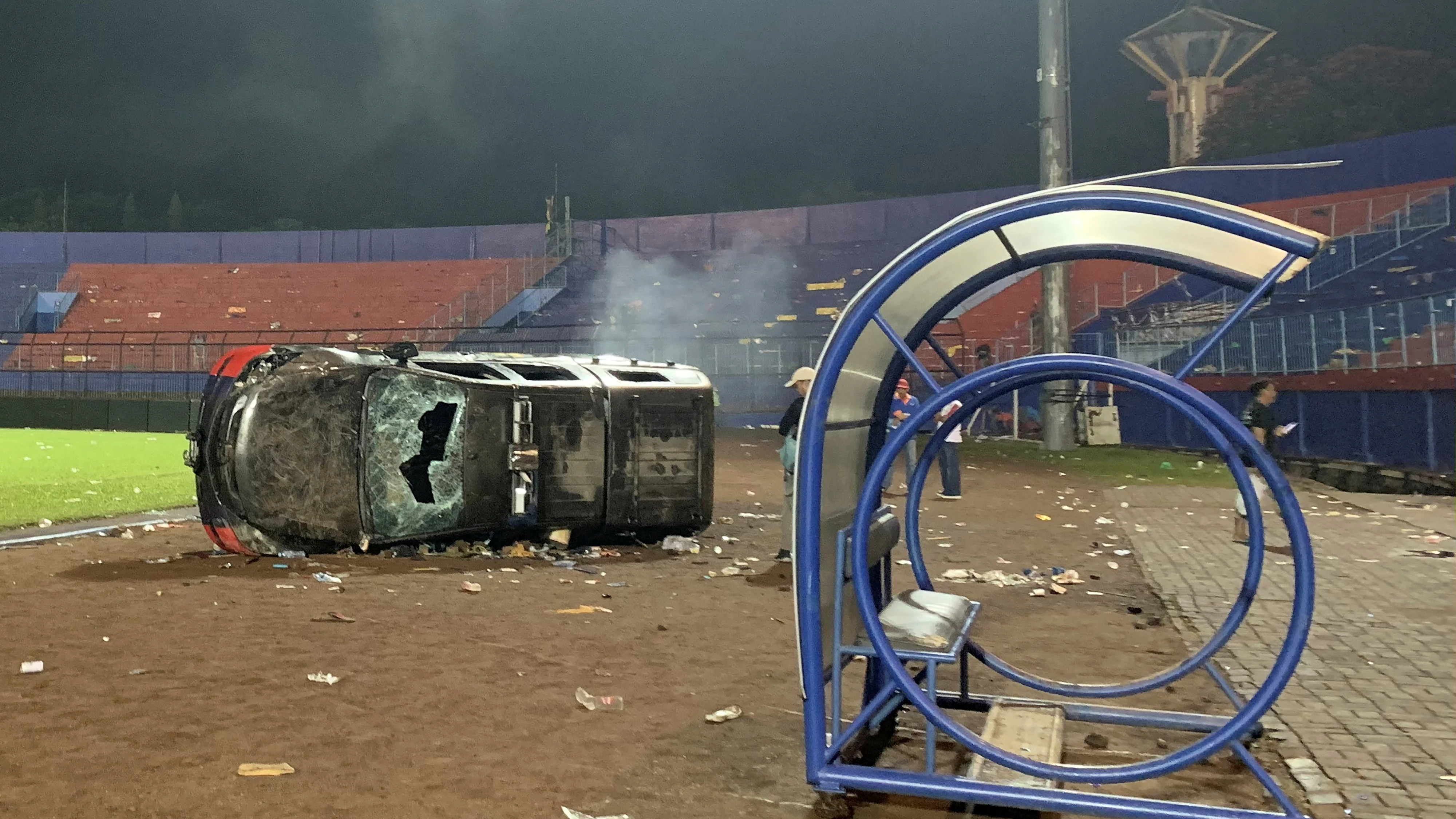 Un coche destrozado y volcado en el estadio Kanjuruhan de Indonesia, donde murieron al menos 125 personas