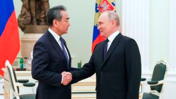 Vladimir Putin saluda a Wang Yi, jefe de la diplomacia china