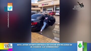 Los ejercicios de equilibrismo de una chica que trata de entrar a su coche sin pisar un charco