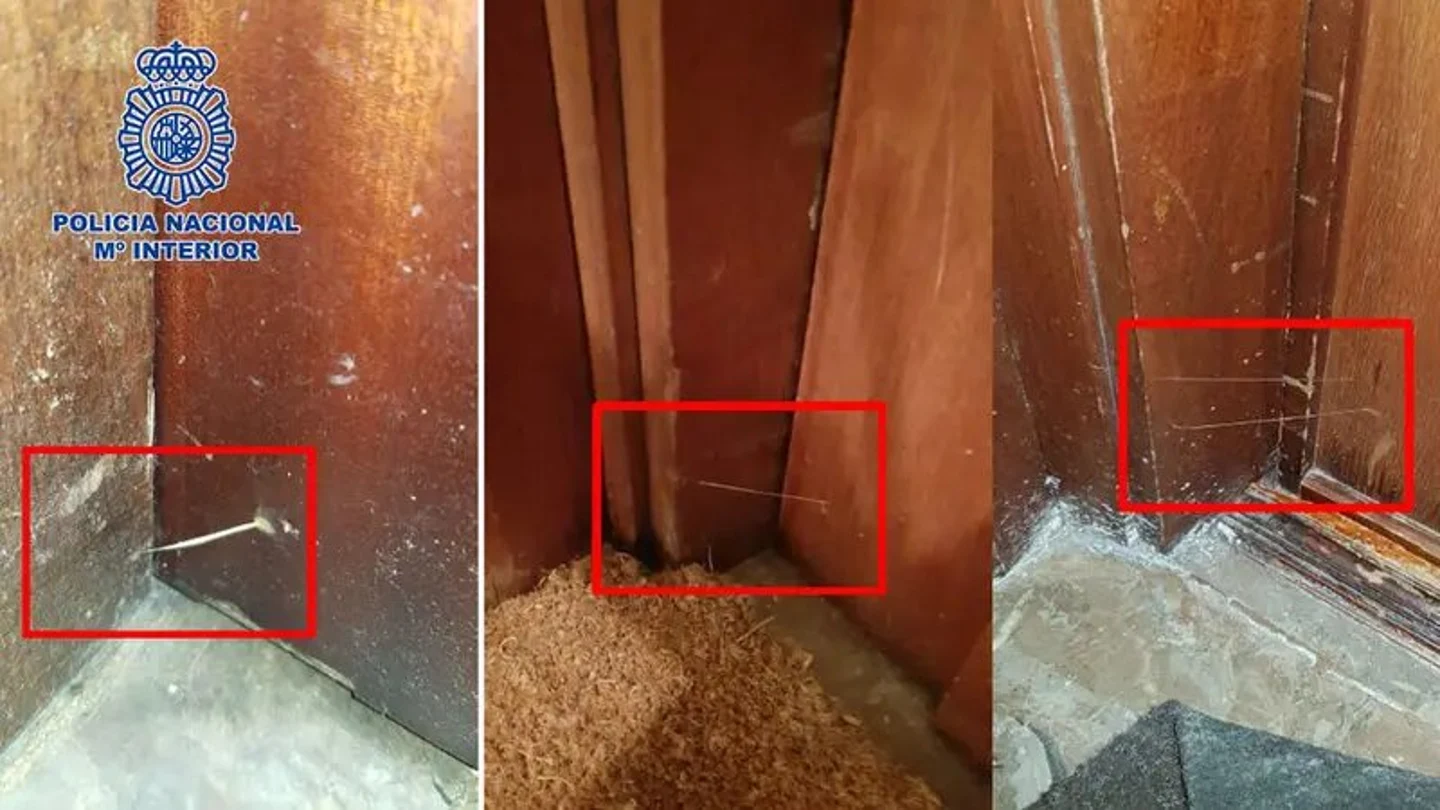 Hilos de plástico pegados entre el marco y la puerta de una vivienda Hilos de plástico pegados entre el marco y la puerta de una vivienda