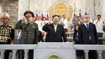 El líder de Corea del Norte, Kim Jong-un (centro), sonríe junto al ministro de Defensa ruso, Serguéi Shoigú (izq), y el miembro del politburó del Partido Comunista Chino Li Hongzhong (dcha), durante el desfile militar del 70 aniversario del fin de la Guerra de Corea, en Pionyang, Corea del Norte.