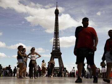 A man arrested after sneaking into the Eiffel Tower and parachuting from its top