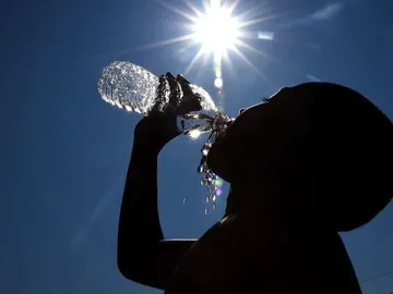 Una persona bebe agua. Una persona bebe agua.