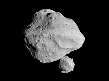 Asteroide Dinkinesh y su pequeña ‘luna’ emergiendo detrás Asteroide Dinkinesh y su pequeña ‘luna’ emergiendo detrás