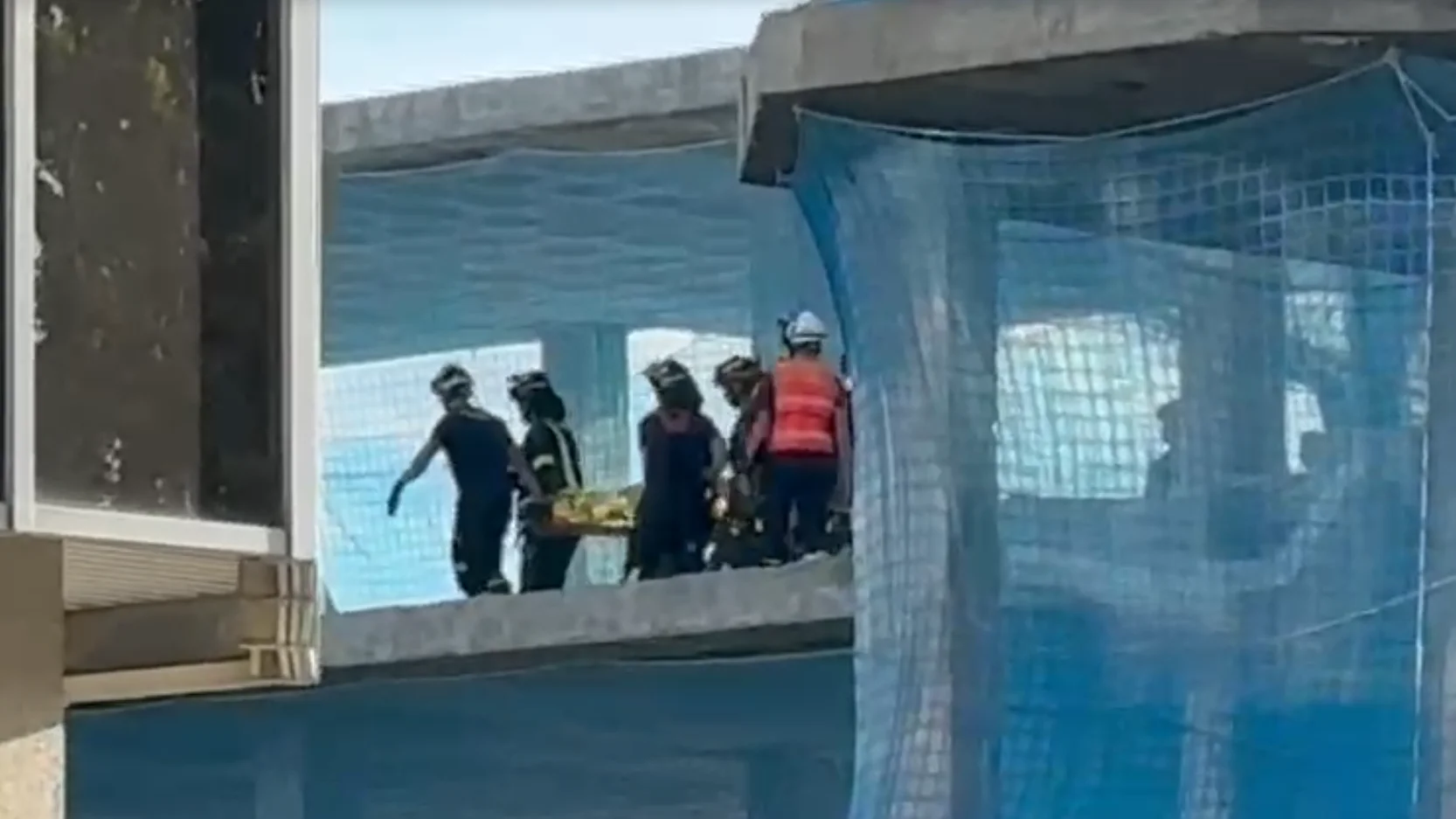 Los Bomberos retiran uno de los cuerpos de los trabajadores fallecidos en el derrumbe de un edificio de Madrid