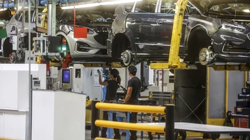 Trabajadores con un vehículo en la fábrica de Ford en Almussafes, Valencia.