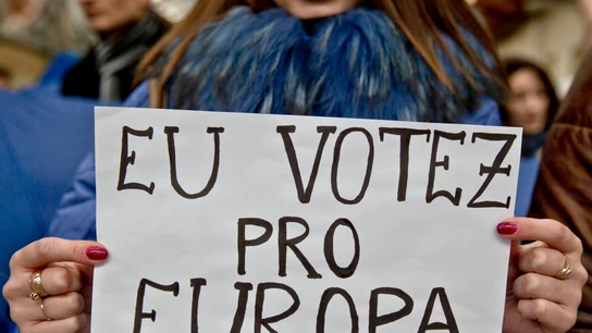 Una joven sostiene un cartel con la frase "yo voto por Europa" en rumano. Una joven sostiene un cartel blanco con la frase "yo voto por Europa" escrita en rumano.