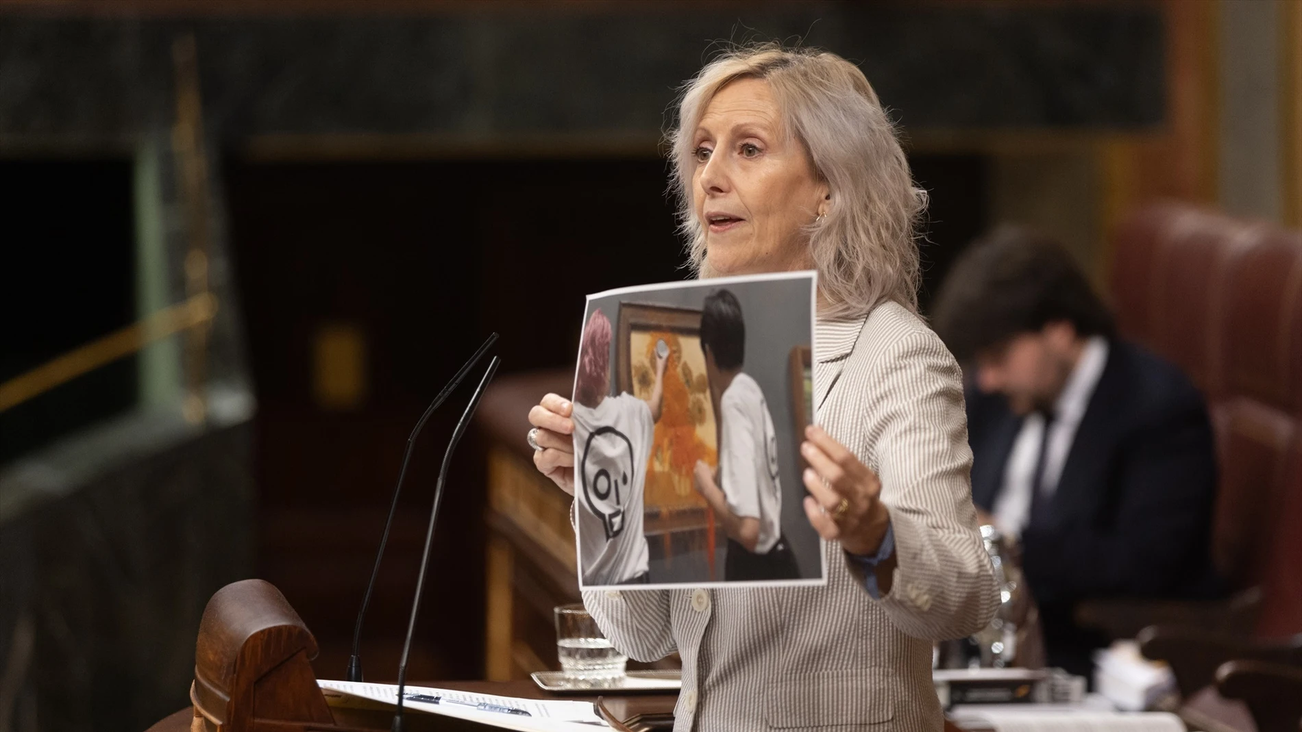 La diputada del PP Marta González muestra una imagen de un acto vandálico durante su intervención durante una sesión plenaria