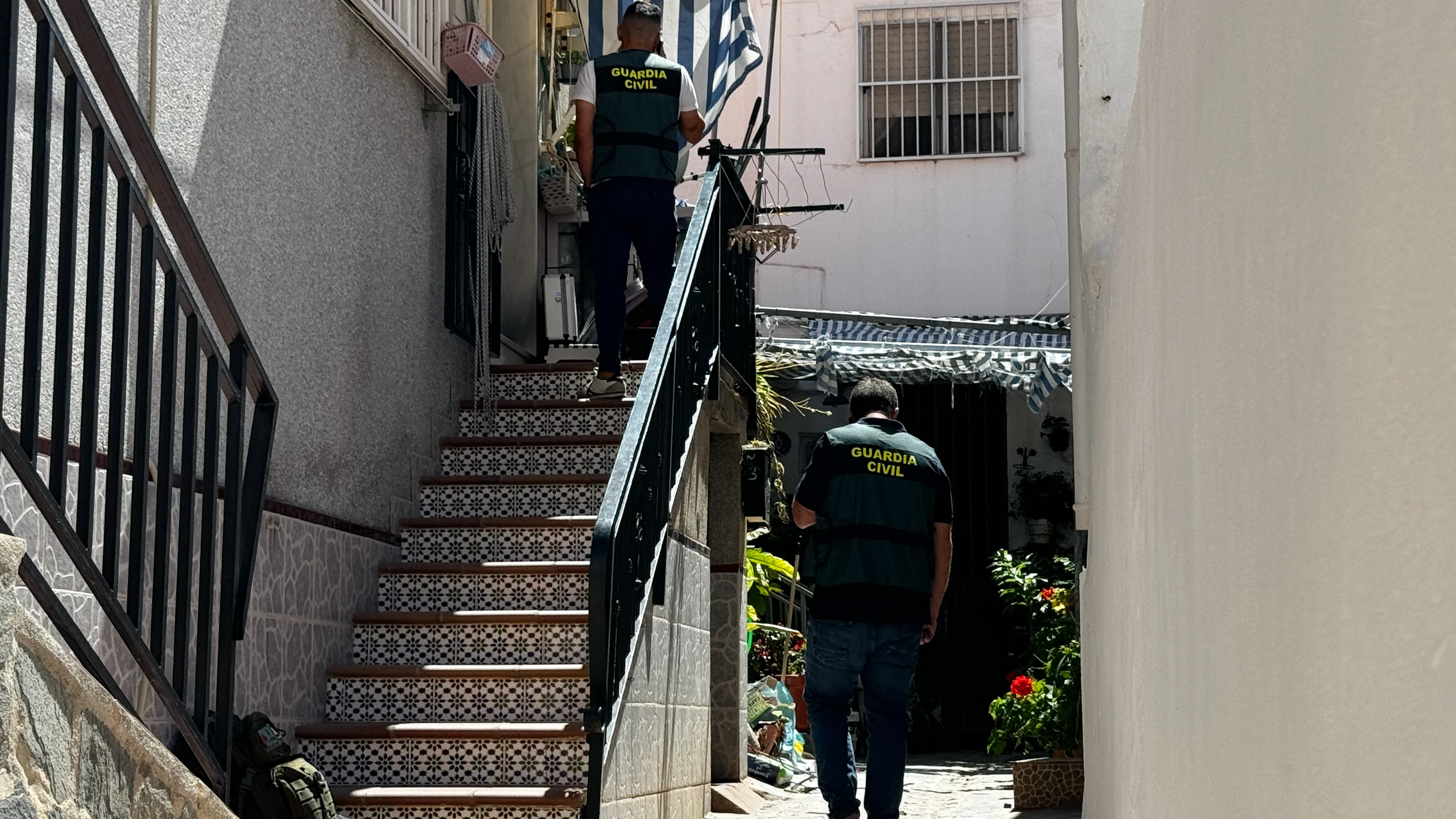 Agentes de la Guardia Civil inspeccionan el exterior de la vivienda en Castell de Ferro (Granada)