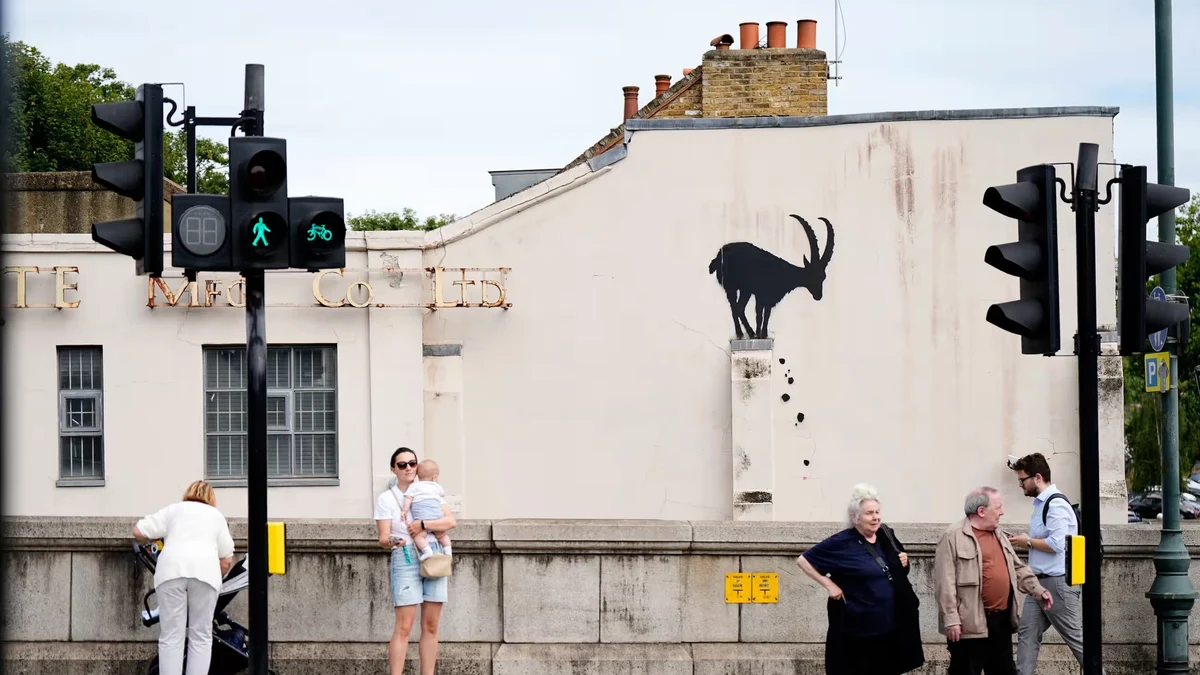Banksy signs a new artwork on a building in southwest London Banksy signs a new artwork on a building in southwest London