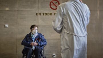 Una señora espera en silla de ruedas en el Complexo Hospitalario Universitario durante la tercera jornada de la huelga de médicos gallegos