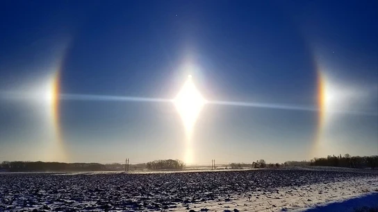 Formación de un parhelio en Minnesota. Formación de un parhelio en Minnesota, un efecto óptico que hace ver tres soles en lugar de uno.