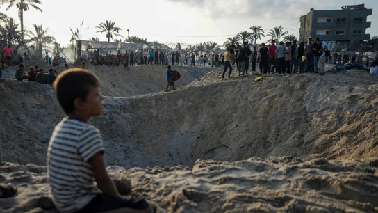 Palestinos observan la destrucción después de un ataque aéreo israelí contra un campo de refugiados lleno de palestinos desplazados por la guerra en Muwasi. Palestinos observan la destrucción después de un ataque aéreo israelí contra un campo de refugiados lleno de palestinos desplazados por la guerra en Muwasi.