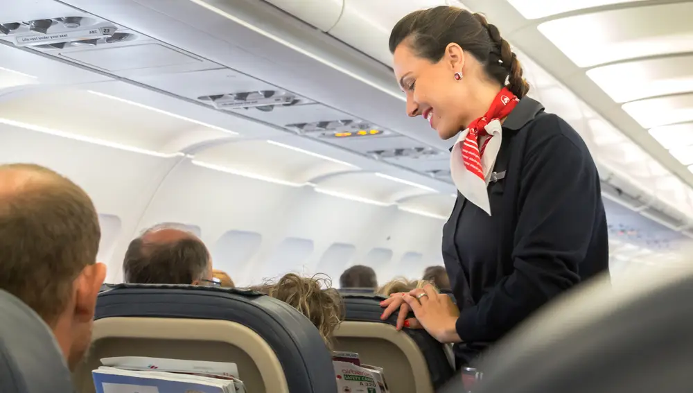 Azafata de vuelo en un avión Azafata de vuelo en un avión