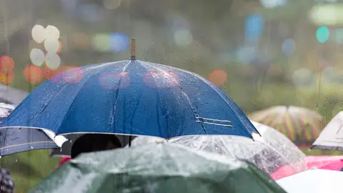 Lluvia en la ciudad y gente con paraguas Lluvia en la ciudad y gente con paraguas