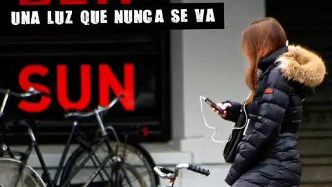 Una mujer mira su teléfono móvil en una imagen de archivo Una mujer mira su teléfono móvil en una imagen de archivo