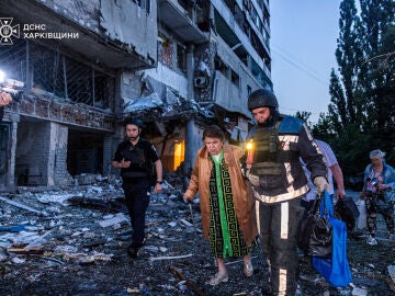 Un rescatista asiste a una mujer durante la evacuación de un edificio en Járkiv.