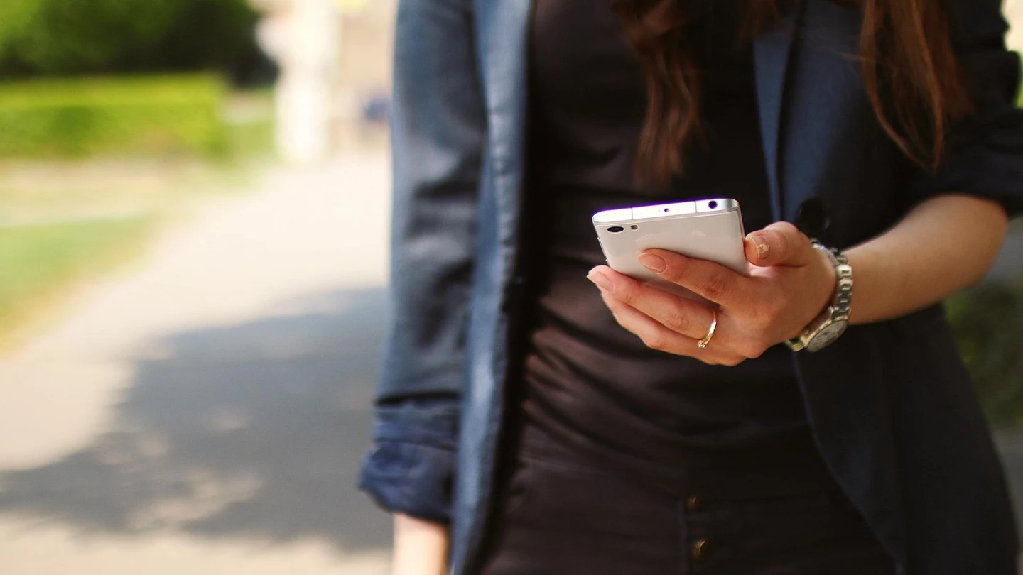Una mujer con un teléfono Una mujer con un teléfono