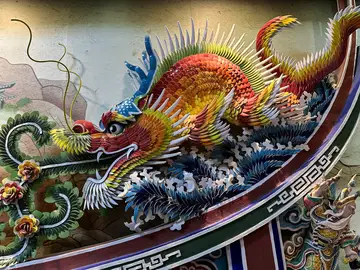 Un dragón compuesto con la técnica del 'jian nian', que utiliza fragmentos de porcelana para crear relieves coloridos en templos y espacios religiosos de Chiayi, condado taiwanés entre montañas cubiertas de nubes, bosques de cipreses, templos centenarios y aromas de té Un dragón compuesto con la técnica del 'jian nian', que utiliza fragmentos de porcelana para crear relieves coloridos en templos y espacios religiosos de Chiayi, condado taiwanés entre montañas cubiertas de nubes, bosques de cipreses, templos centenarios y aromas de té