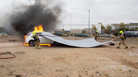 Prueba de extinci&oacute;n de fuego en un coche el&eacute;ctrico con una manta ign&iacute;fuga