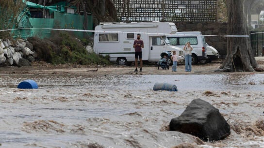 Varias personas observan el barranco de Arguineg&iacute;n ante la crecida del caudal del barranco