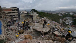 Los equipos de rescate registran los escombros de un edificio que se derrumb&oacute; durante los terremotos en La Guaira, Venezuela.