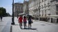 Imagen de archivo. Varias personas protegi&eacute;ndose del sol frente al Palacio Real en Madrid.